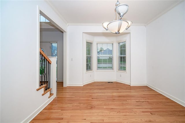 2500 Gabrianna Ct, Columbia, MO 65203 - unfurnished dining area featuring baseboards, a chandelier, light wood-style floors, ornamental molding, and stairs