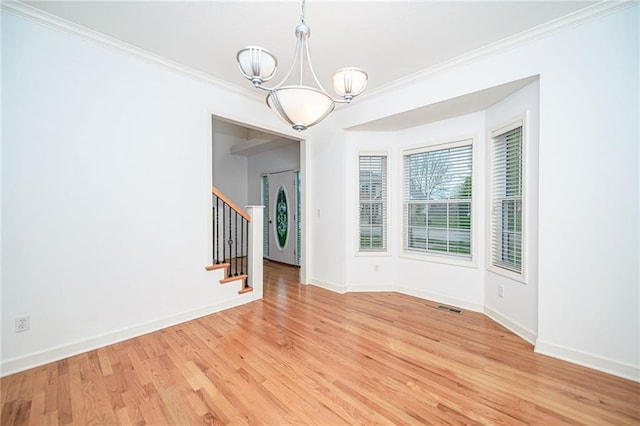 2500 Gabrianna Ct, Columbia, MO 65203 - unfurnished dining area with visible vents, light wood-type flooring, ornamental molding, and an inviting chandelier