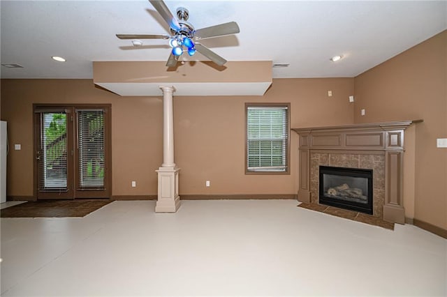2500 Gabrianna Ct, Columbia, MO 65203 - unfurnished living room featuring a healthy amount of sunlight, a tiled fireplace, ceiling fan, and baseboards