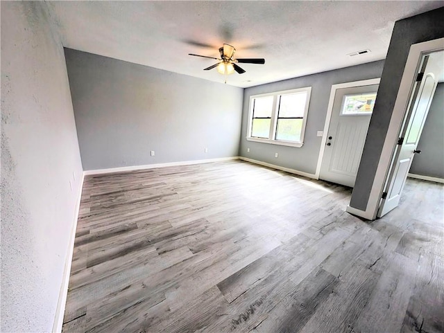 597 SE 110th St, Warrensburg, MO 64093 - unfurnished living room with baseboards, ceiling fan, and wood finished floors
