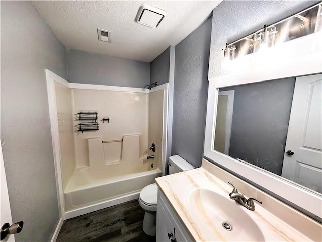 597 SE 110th St, Warrensburg, MO 64093 - full bath featuring a textured wall, vanity, toilet, wood finished floors, and visible vents