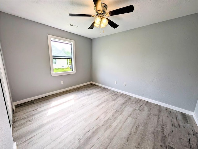 597 SE 110th St, Warrensburg, MO 64093 - unfurnished room with visible vents, a ceiling fan, baseboards, and wood finished floors