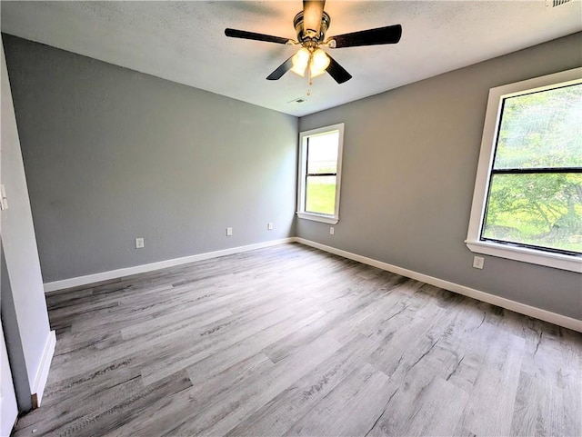 597 SE 110th St, Warrensburg, MO 64093 - empty room with baseboards, wood finished floors, and a wealth of natural light