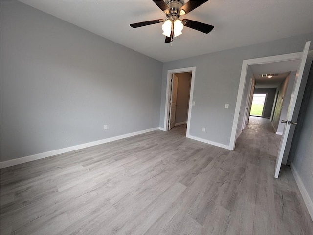 597 SE 110th St, Warrensburg, MO 64093 - unfurnished bedroom with a ceiling fan, baseboards, and wood finished floors