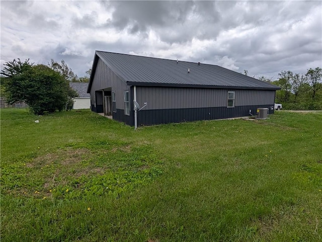 597 SE 110th St, Warrensburg, MO 64093 - exterior space featuring a lawn, metal roof, and central air condition unit