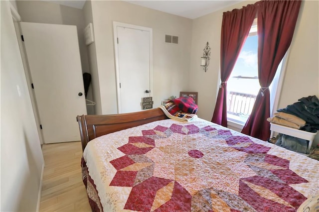 bedroom featuring visible vents, multiple windows, and light wood-type flooring