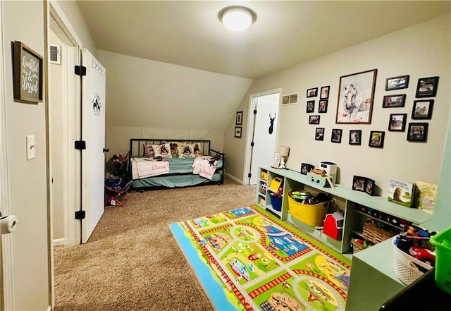 bedroom with visible vents, carpet, and vaulted ceiling