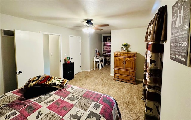 carpeted bedroom featuring ceiling fan and visible vents