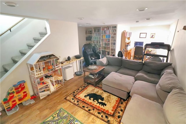 living room with wood finished floors and stairway