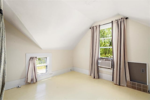 additional living space featuring vaulted ceiling and cooling unit