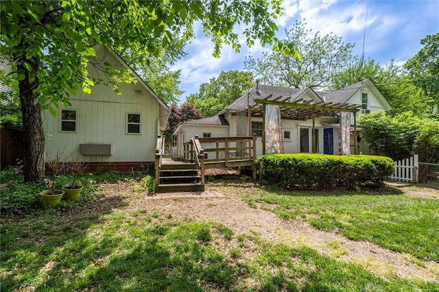 back of house with a deck and a pergola