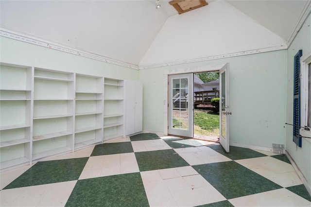 unfurnished room with high vaulted ceiling