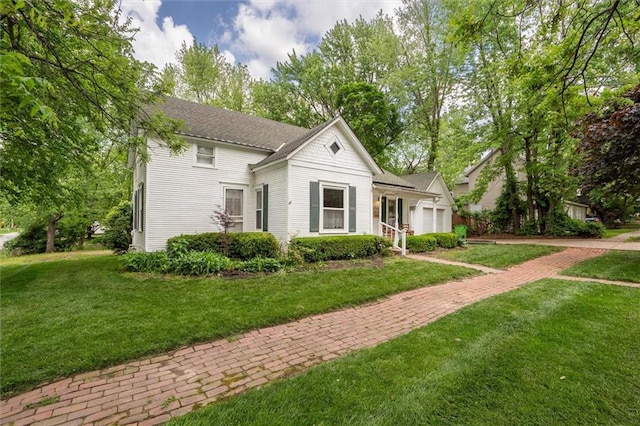 view of front of home with a garage and a front lawn