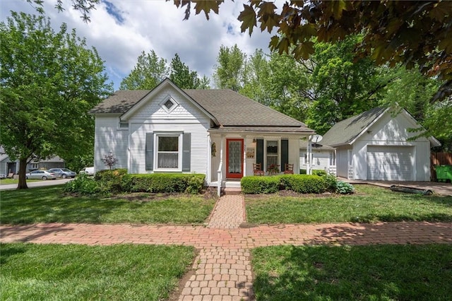 view of front of property with a front lawn, an outbuilding, and a porch