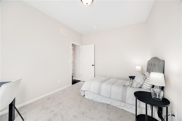 carpeted bedroom featuring baseboards and visible vents