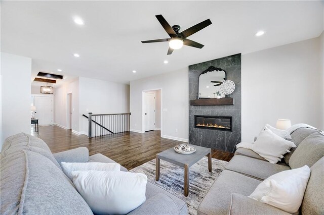 living room with recessed lighting, wood finished floors, and a tile fireplace