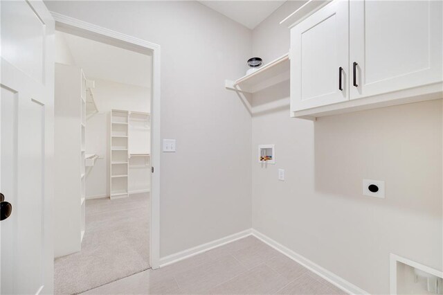 laundry area featuring baseboards, hookup for a washing machine, cabinet space, and hookup for an electric dryer