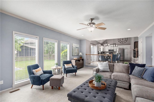 carpeted living area featuring crown molding, a chandelier, ceiling fan, a textured ceiling, and baseboards
