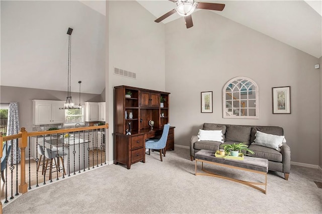 living area featuring high vaulted ceiling, a ceiling fan, light carpet, and baseboards