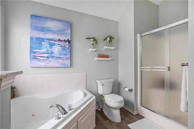bathroom featuring wood finished floors, toilet, a stall shower, a whirlpool tub, and baseboards