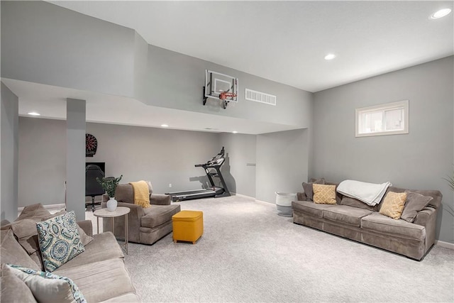 carpeted living area featuring recessed lighting and baseboards