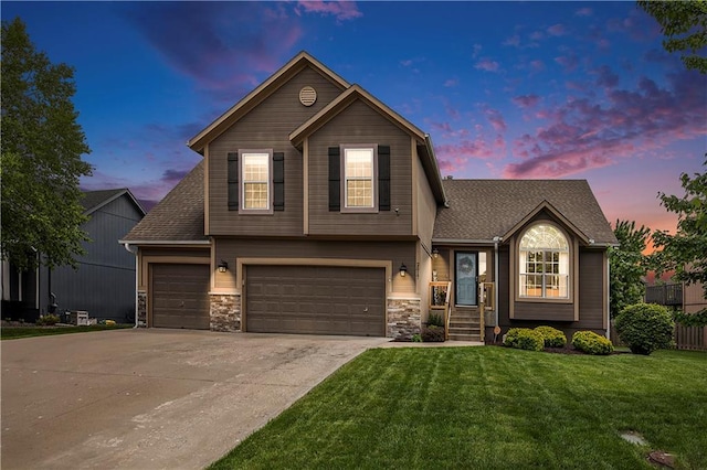 view of front of property with a front yard, driveway, an attached garage, stone siding, and roof with shingles