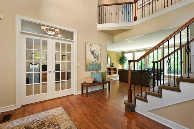 7419 Constance St, Shawnee, KS 66216 - entrance foyer with wood finished floors, stairs, french doors, a towering ceiling, and baseboards