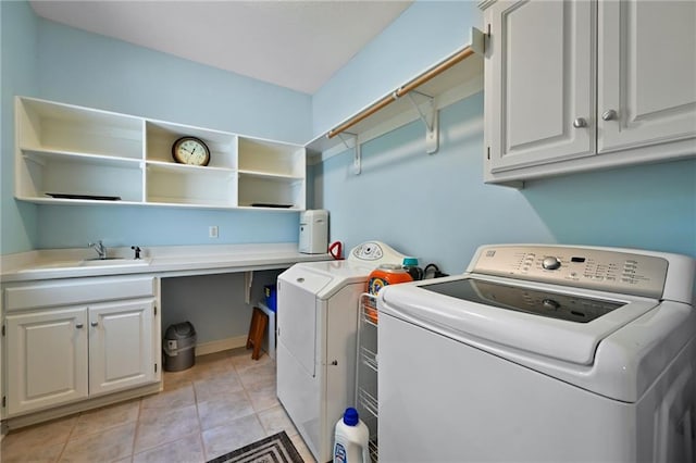 7419 Constance St, Shawnee, KS 66216 - laundry area featuring washer and clothes dryer, cabinet space, and light tile patterned floors