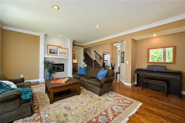 7419 Constance St, Shawnee, KS 66216 - living room featuring a tile fireplace, crown molding, wood finished floors, stairway, and baseboards