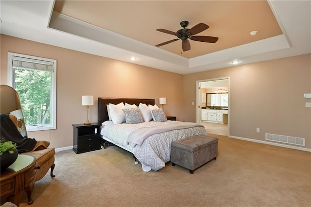 7419 Constance St, Shawnee, KS 66216 - bedroom with a tray ceiling, light carpet, baseboards, recessed lighting, and connected bathroom
