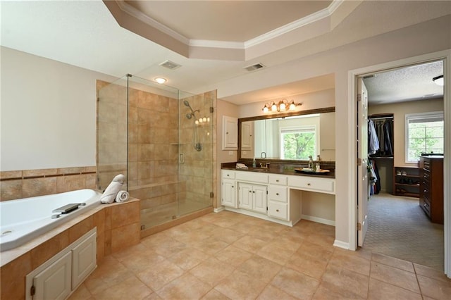 7419 Constance St, Shawnee, KS 66216 - bathroom featuring a tray ceiling, a shower stall, vanity, crown molding, and a bath