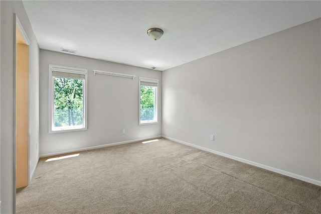 7419 Constance St, Shawnee, KS 66216 - spare room with baseboards, healthy amount of natural light, and carpet flooring