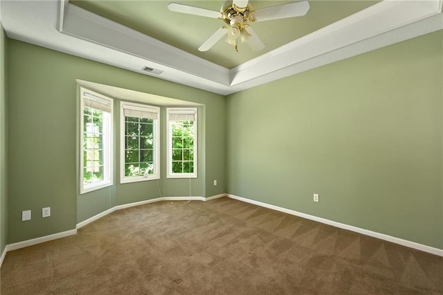7419 Constance St, Shawnee, KS 66216 - empty room featuring a tray ceiling, dark colored carpet, a ceiling fan, baseboards, and ornamental molding