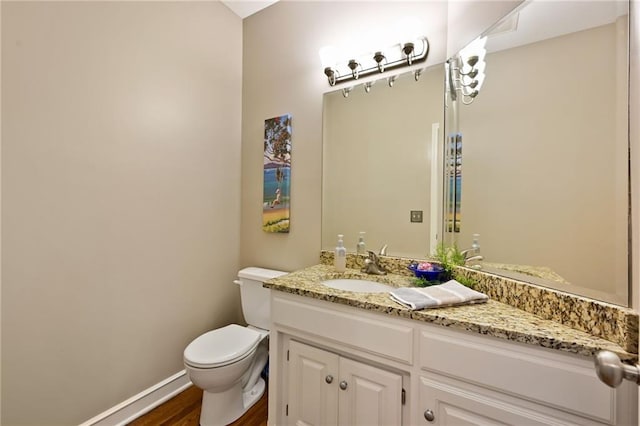 7419 Constance St, Shawnee, KS 66216 - half bath with vanity, toilet, wood finished floors, and baseboards