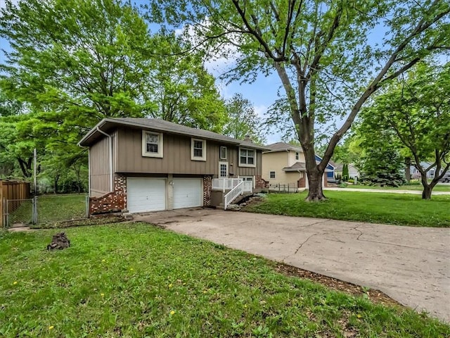 raised ranch featuring driveway, a garage, brick siding, fence, and a front lawn