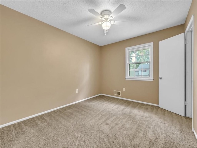 unfurnished bedroom featuring visible vents, a textured ceiling, carpet floors, and baseboards