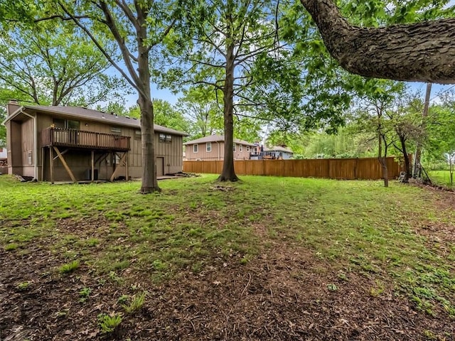 view of yard featuring fence and a wooden deck