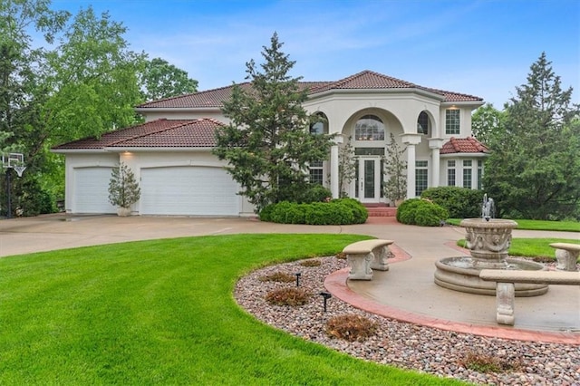 mediterranean / spanish house with a tiled roof, a front lawn, an attached garage, concrete driveway, and stucco siding