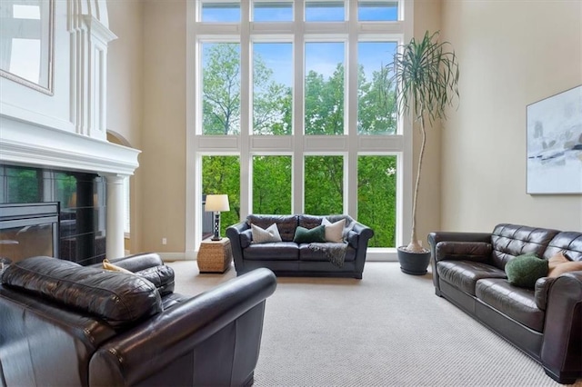 carpeted living room with a high ceiling