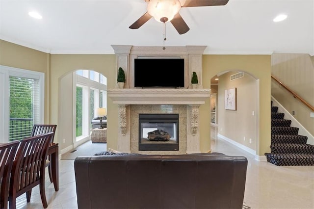 living area featuring a ceiling fan, crown molding, baseboards, light tile patterned flooring, and recessed lighting