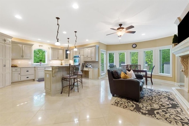 living area featuring ceiling fan, recessed lighting, a premium fireplace, and baseboards