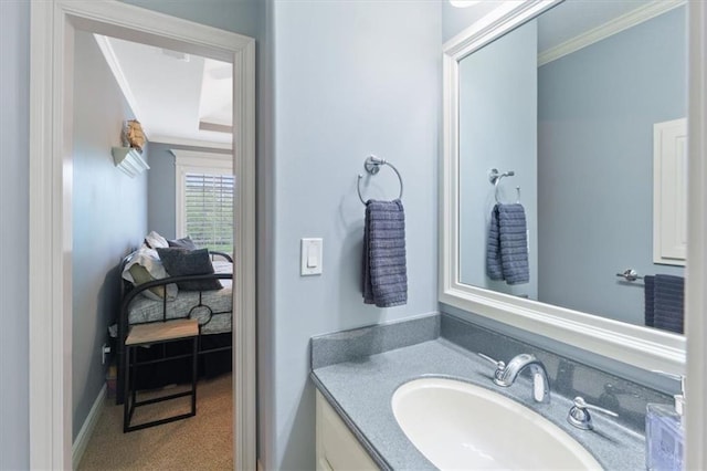 bathroom with crown molding, vanity, and baseboards