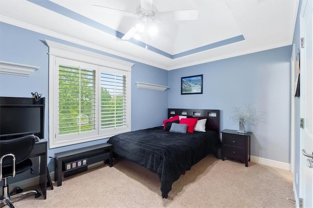 bedroom with carpet flooring, a raised ceiling, ornamental molding, baseboards, and ceiling fan