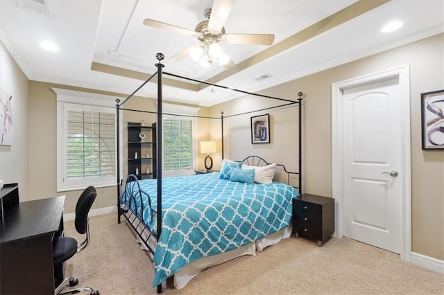 bedroom featuring a tray ceiling, carpet, crown molding, baseboards, and ceiling fan