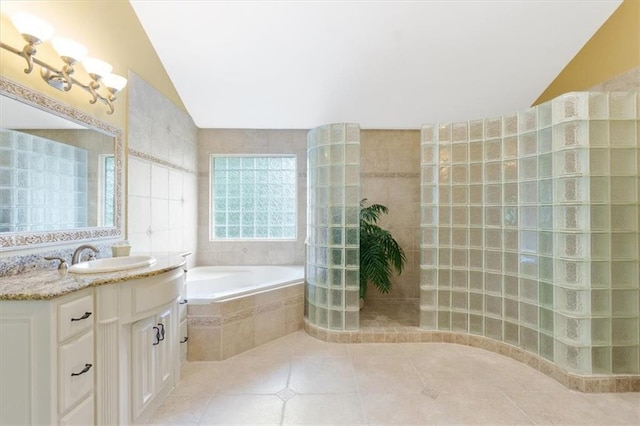 bathroom with lofted ceiling, walk in shower, tile patterned flooring, a garden tub, and vanity