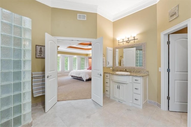 bathroom featuring crown molding, connected bathroom, tile patterned floors, vanity, and baseboards