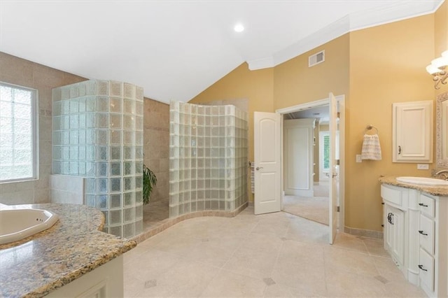 full bath with a walk in shower, vanity, lofted ceiling, and tile patterned floors