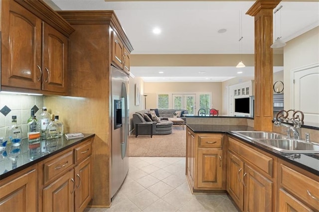 kitchen featuring open floor plan, stainless steel fridge with ice dispenser, a sink, light carpet, and light tile patterned floors