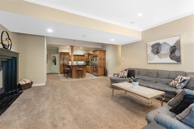 living room featuring crown molding, recessed lighting, light colored carpet, a fireplace with flush hearth, and baseboards