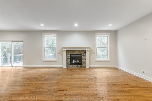 875 Clearview Dr, Lansing, KS 66043 - unfurnished living room with a fireplace, light wood-style flooring, and recessed lighting